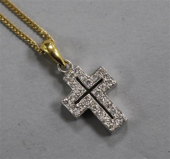 An 18ct white gold and diamond cross pendant, on an 18ct gold chain, 17mm.
